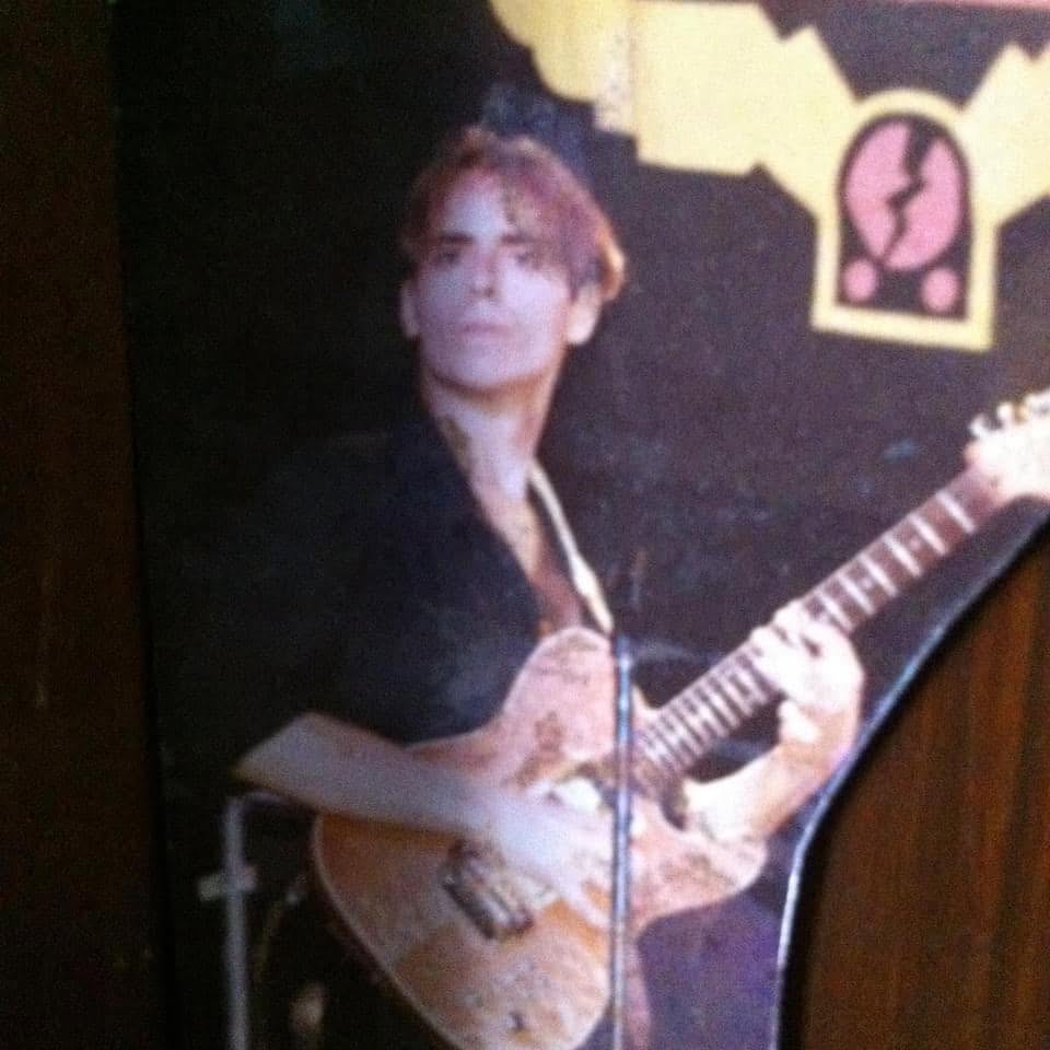 A young Moshe Antelis playing electric guitar